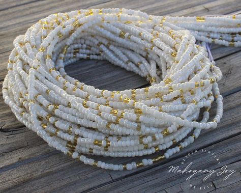 【 𝐓𝐇𝐈𝐒 𝐋𝐈𝐒𝐓𝐈𝐍𝐆 𝐈𝐒 𝐅𝐎𝐑 】 * White & Gold Mix Waist Beads * Handcrafted using our 2mm signature beads for no bulk and pure comfort 【 𝐘𝐎𝐔𝐑 𝐎𝐑𝐃𝐄𝐑 】 * Customizable Length: Our waist beads are designed with you in mind. This set is available in 17 to 60 inches, allowing you to find the perfect fit for your unique style and body shape. * Screw Clasp & Tie-On Closures: For those new to waist beads or seeking freedom and versatility, we highly recommend our nickel-free screw clasp closure. If you're more experienced, our tie-on waist beads are a favorite, complete with a sample of super glue for securing your knots. * Symbolism of Colors: White represents purity, clarity and a fresh start. As a blank canvas, they symbolize the beginning of a new chapter, offering a sense of Gold Waist Beads, Waist Beads African, Beads Waist, Belly Beads, Period Tracker, Beading Cord, Tools For Women, Body Adornment, Waist Beads