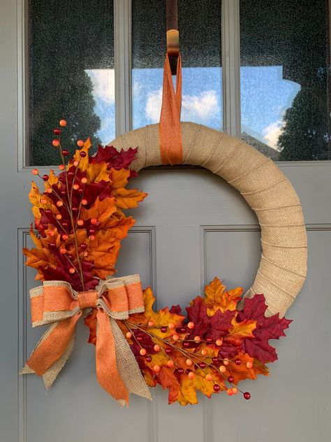 Beautiful burlap wrapped wreath accented with Fall colored leaves and detailed with a handmade burlap & orange bow. Diy Autumn Wreath For Front Door, Fall Wreaths Dollar Tree, Dollar Tree Thanksgiving Wreath, Easy Fall Wreaths Diy, Autumn Wreaths For Front Door Diy, November Wreath, Fall Crafts Dollar Tree, Fall Wreaths Diy, Burlap Wrapped Wreath