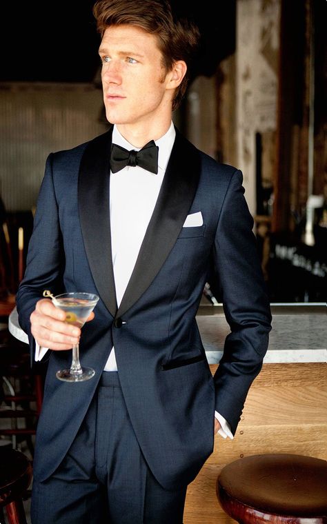 Inspired by James Bond's iconic tuxedo, it features a midnight blue twill wool with the standard tuxedo satin trimmings on the lapel, pocket besom, buttons and pant outseam. The one button dinner jacket is half canvassed with a black paisley lining, the trousers come with adjustable side tabs and suspender buttons. Midnight Blue Tuxedo Wedding, Blue Tuxedo Wedding, Navy Blue Tuxedos, Prom Blazers, Navy Tuxedos, Blue Tuxedo, Wedding Tux, Blue Suit Men, Blue Tuxedos