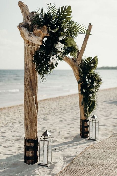 dramatic driftwood beach wedding arch with palm fronds Beach Wedding Arches Ideas, Driftwood Arbor Wedding, All Black Beach Wedding, Wedding Arches Beach, Drift Wood Wedding Arch, Driftwood Beach Wedding, Driftwood Arch Wedding, Green And White Beach Wedding, Unique Wedding Arbor