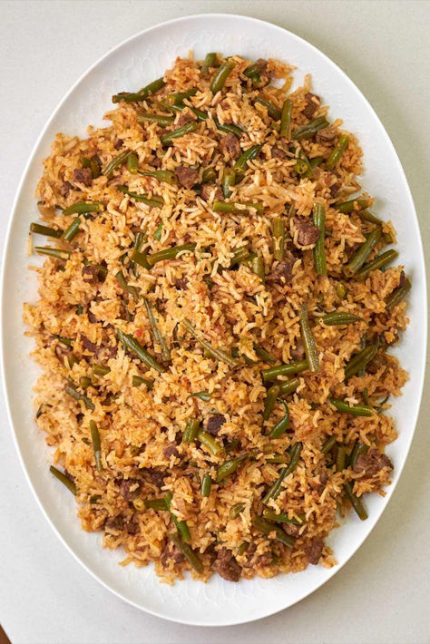 Plate of yellow rice with green beans and beef Loobia Polo Recipe, Lubia Polo Recipe, Loobia Polo, Rice And Green Beans, Persian Rice, Persian Green, Tomato Rice, Green Beans And Tomatoes, Rice Dish