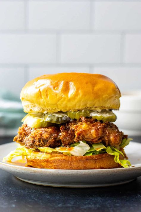 Crispy fried chicken thighs drizzled with hot honey sauce then nestled between crunchy lettuce and pickles on a toasted brioche bun. Hot Honey Chicken Sandwich, Honey Chicken Sandwich, Creamy Parmesan Rice, Zucchini Pasta Salad, Crispy Chicken Sandwich, Hot Honey Chicken, Chicken Sandwich Recipe, Crispy Chicken Sandwiches, Creamy Chicken And Rice