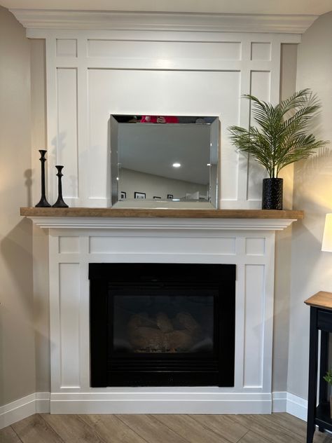 White shaker fireplace with natural wood stained mantle White Mantle With Wood Top, Wood And White Fireplace, Shaker Style Fireplace Surround, White Trim Fireplace, White Wood Mantle Fireplace, White Fireplace Surround Wood Mantle, Wood Mantle Slipcover, Shaker Fireplace Mantel, Wood Mantle Surround