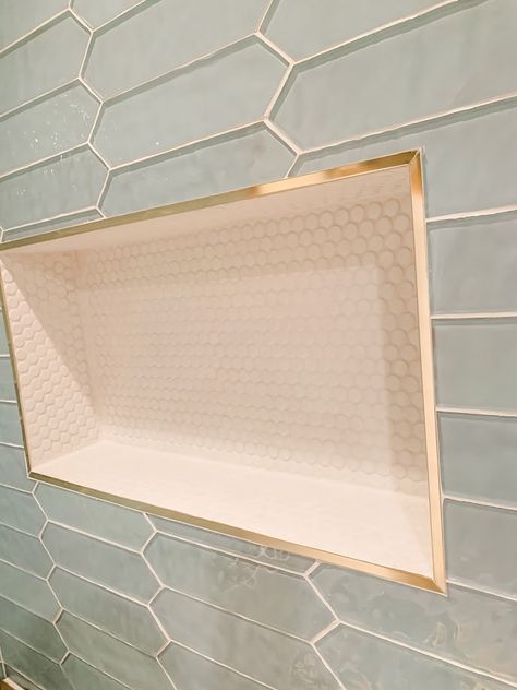 Shower niches are a great way to add storage and interest in your shower. High gloss penny tile and glass pickets accented with gold metal trim makes this pop! Shampoo Shelf In Shower, Cottage Shower Tile Ideas, Shower Nook Ideas, Modern Master Bathrooms 2024 Trends, Timeless Bathrooms, Bad Inspiration, Master Bath Remodel, Shower Niche, Bidet Toilet