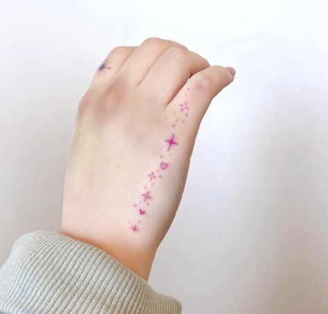 Butterflies With Sparkles Tattoo, Pink Girly Tattoos, Pink Sparkle Tattoo, Kawaii Hand Tattoo, Small Pink Tattoo, Pink Hand Tattoo, Pastel Tattoo Ideas, Hand Sparkle Tattoo, Sparkle Tattoo Hand