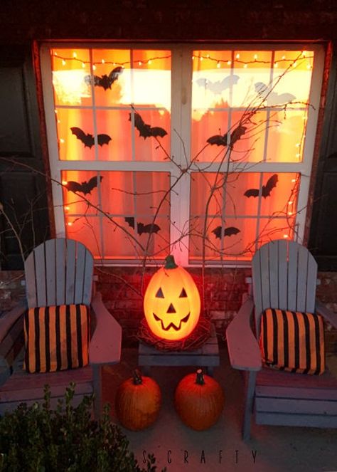 Halloween porch with orange lights at night Halloween Porch Pumpkins, Halloween Lights Outdoor Porch Simple, Halloween Night Decorations, Halloween Themed Front Porch, Long Porch Halloween Decor, Front Halloween Decor, Deck Decorating Halloween, Sit Halloween Decorations, Fall House Decorations Outdoor