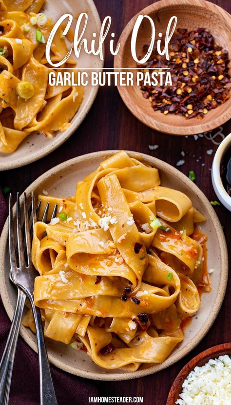 A bowl of chili oil garlic butter pasta with a fork for eating, a second bowl of pasta and garnishes like red pepper flakes and parmesan are in the background. Crunchy Garlic Chili Oil, Homemade Chili Oil, Garlic Chili Oil, Garlic Butter Noodles, Crunchy Garlic, Garlic Noodles Recipe, Garlic Butter Pasta, Chili Oil Recipe, Potato Pasta