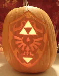 Pin for Later: 27 Geeky Pumpkins to Inspire Your Halloween Decor Hylian Shield From Zelda Pumpkin Zelda Pumpkin, Pumpkin Carving Patterns Free, Easy Pumpkin Carving, Pumpkin Carving Designs, Pumpkin Template, Pumpkin Carving Patterns, Pumpkin Carvings Stencils, Pumpkin Stencil, Pumpkin Carving Templates