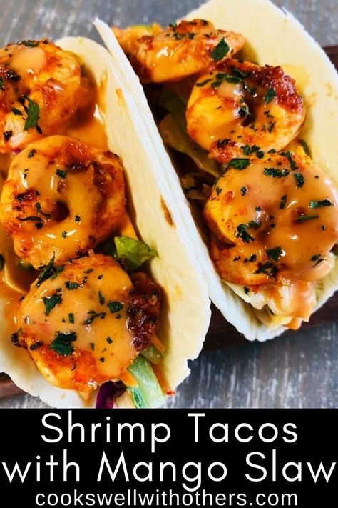 two shrimp tacos with spicy sauce over top Mango Slaw Recipes, Shrimp Taco Sauce, Shrimp Mango, Sweet Chili Shrimp, Seasoned Shrimp, Shrimp Tacos Easy, Chili Shrimp, Mango Slaw, Spicy Shrimp Tacos