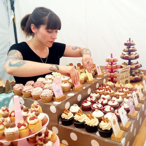 Dubbed London’s “badass baker,” today's #WCW goes out to @jemmajemma. This confectionary wizard has been making the Internet a sweeter place thanks to her @cupcakejemma channel on Jamie Oliver's 1.8 million-strong YouTube network Food Tube. Besides churning out cake-decorating tutorials and recipe walkthroughs, this pastry chef feeds hungry customers with wild flavors at her So-Ho bakery Crumbs and Doilies. #Cupcakes #Baking #CupcakeJemma Bake Sale Display Table Cupcake Stands, Cupcake Sale Display, Bake Stall Ideas, Bake Sale Table Ideas, Cupcake Stall Display Ideas, Cupcake Sale Ideas, Cupcake Market Stall, Dessert Stall Ideas, Cake Booth Display Ideas