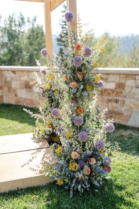 Purple And Orange Flowers Wedding, Tangled Wedding Flowers, Flower Poles Wedding, Wildflower Wedding Chuppah, Allium Wedding Flowers, Lavender Chuppah, Green Purple Yellow Wedding, Blue Purple Yellow Wedding, Orange And Purple Wedding Flowers