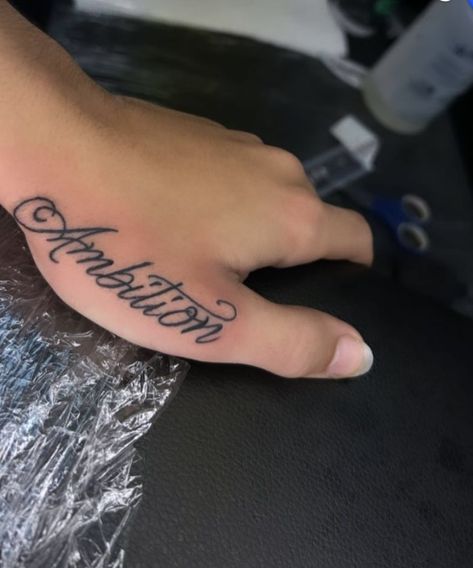 Ambition Hand Tattoo, Side Of Hand Tattoos For Women Word, Ruthless Tattoo, Name Tattoos For Men Forearm, Real Hasta La Muerte Tattoo, Hand Name Tattoos, Name Tattoo Placement, Hand Written Tattoos, Ambition Tattoo