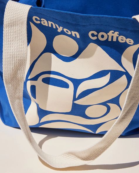 The Canyon Tote Bag | Canyon Coffee | Los Angeles Coffee Company Tote Bag Graphic Design, Cleaning Tote, Corporate Branded Gifts, Coffee Tote Bag, River Design, Branded Tote Bags, Blue Cafe, Canvas Bag Design, Graphic Motif