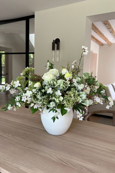 Ranunculus, Hellebores, Blossom and Hydrangea in a White Stone Vase Leafy Flower Arrangements, Flowers In White Vase, Large Vase Flower Arrangements, Flower For Dining Table, Kitchen Island Flower Arrangement, Dining Table Flower Vase, Home Centerpieces, White Vase Arrangement, Flower Dining Table Decor