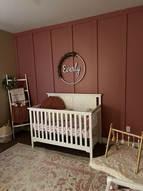 We did the accent wall ourselves with 1 in x 2 in strips of wood from home depot. The paint color is “cherry juice” from behr. Behr Cherry Juice, Accent Wall Baby Girl Nursery, Moody Pink Nursery, Maroon Accent Wall Bedroom, Cherry Wood Nursery, Wood Accent Wall Nursery, Maroon Accent Wall, Nursery With Accent Wall, Dark Pink Nursery