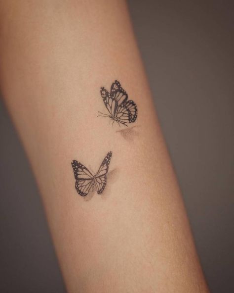 Micro-realistic butterflies tattooed on the upper arm. Side View Butterfly Tattoo Simple, Micro Realistic Butterfly Tattoo, Ingenue Tattoo, Wrap Around Forearm Tattoo Women Butterflies, Floating Butterfly Tattoo, Butterfly Tattoo Closed Wings, Butterflies Tattoo Wrist, Perched Butterfly Tattoo, Inner Arm Butterfly Tattoos For Women