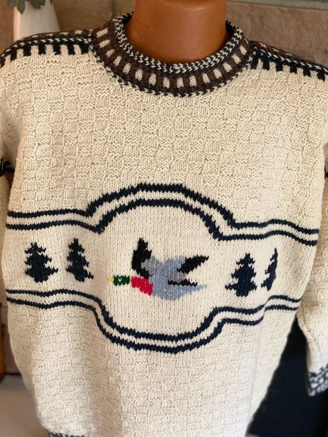 Attention all birders and waterfowl hunters! Whether you're out with your binoculars trying to capture the sight of another bird on your list or waiting for hours in the blind with only your Labrador Retriever to keep you company, the 'Duck' pattern hand knitted sweater is going to keep you warm! This gorgeous pullover has a duck as its central motif, framed by trees on the sides and double black yarn knitted lines, with a small rectangular knitted pattern comprising the cream colored upper ches Vintage Fall Sweater, Knitted Sweaters Pattern, Anatomy Sweater, Knit Jumper Pattern, Vintage Sweater Pattern, Duck Sweater, Fall Knitting Patterns, Preppy Handbook, Duck Pattern