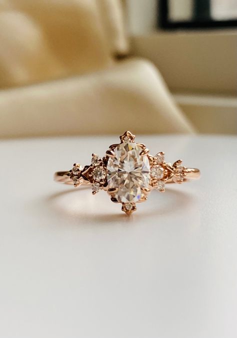 Enchanted moissanite 14k rose gold engagement ring gold. Dela whimsical filigree design by EidelPrecios. This engagement ring features an 1ct white moissanite, 5x7mm, sparkling and clean. It is set our new Dela fantasy inspired setting, 14k rose Gold, 12 white moissanites on the sides. This ring would make a beautiful unique engagement ring or promise ring as well as anniversary gift. It comes in a gorgeous rose wood ring box, ready to present. Details: Center stone: moissanite  approx. 1ct (5x7 Engagement Rings Fairy, Ethereal Engagement Ring, Fairytale Wedding Ring, Engagement Ring Gold, Pretty Engagement Rings, Moissanite Engagement Ring Rose Gold, Cute Engagement Rings, Future Engagement Rings, Rose Wood