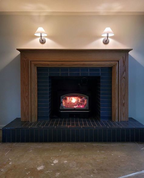 First fire in the newly renovated fireplace 🔥 Our Ohio farmhouse project just got cozier Swipe to see the before and after of this fireplace transformation! Our team furred out the wall over the original brick surround, added a warm wood mantel and a rustic denim blue tiled hearth, and refreshed the existing wood-burning stove. Tiled Hearth, Fireplace Transformation, Wood Mantel, Pellet Stove Inserts, Fire Surround, Wood Mantels, Fireplace Surround, Pellet Stove, Brick Fireplace