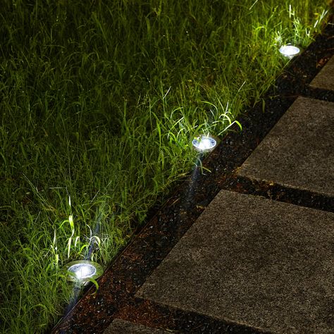 "Buy Glitzhome® 5.25\" Solar Powered LED Pathway Ground Lights Set at Michaels. com. These stylish and portable solar disk lights are made of high quality plastic and stainless steel. The solar panel keeps the rechargeable battery charged in the sunlight and is ready to light up the pathway in your garden, yard or patio at night. These stylish and portable solar disk lights are made of high quality plastic and stainless steel. The solar panel keeps the rechargeable battery charged in the sunligh Solar Lights Front Yard, Lawn Lighting Ideas, Path Lighting Walkways, Ground Lights Outdoor, Patio At Night, Ground Lighting, Ground Lamp, Path Way, Lawn Ideas