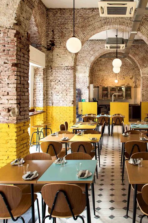 The exposed-brick arches at Berberè Navigli pizzeria in Milan are dipped in buttery-yellow paint. Dim Sum Restaurant, Pizzeria Design, Bar In Casa, Kursi Bar, Industrial Restaurant, Yellow Interior, Modern Restaurant, Bar Interior, Coffee Shop Design