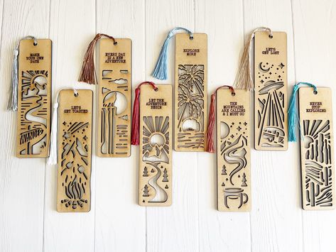 Introducing our delightful Set of 8 Wooden Adventure Bookmarks with Tassels and Inspiring Nature Quotes! Each of these bookmarks features an enchanting outdoor nature scene, ready to whisk you away to endless literary adventures. Crafted with care, these sturdy wooden bookmarks are cut out in intricate designs, creating a visual treat for your reading pleasure.  Measuring 6.75 x 1.75 inches, they fit perfectly inside any book, keeping your place with style. The set includes all eight bookmarks, Glowforge Bookmark, Laser Bookmark, Wooden Bookmarks, Book Keeping, Wood Bookmark, Anime Crafts Diy, Inspiring Nature, Diy Laser Cut, Diy Bowl