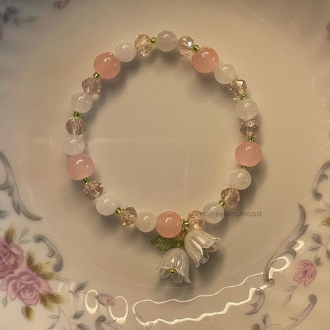 my lily of the valley bracelet 🪷 . . . . . . . . . . . #explore #explorepage #jewelry #beadwork #beads #beadsoup #charms #bracelets #etsy #etsyfinds #beadjewelry #beadbracelets #coquette #coquetteaesthetic #coquettefashion #coquettegirl #pastelaesthetic #lilyofthevalley #beadsbracelet #flowers Cute Bracelets Ideas Beads, Coquette Bracelets, Coquette Bracelet, Lily Bracelet, Bracelets Etsy, Pretty Jewelry Necklaces, Diy Jewelry Unique, Charms Bracelets, Bead Charms Diy