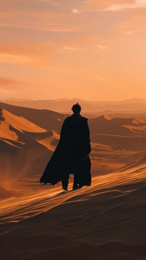 The image shows a lonely figure standing on a sand dune in the middle of a vast desert. The figure is wearing a long black cloak and is facing away from the viewer ->> more details in ai-img-gen.com Julian Aesthetic, Black Sand Desert, Scifi Ideas, Apocalypse Landscape, Giant Skeleton, Book Couples, Desert Aesthetic, Black Cloak, Silhouette People