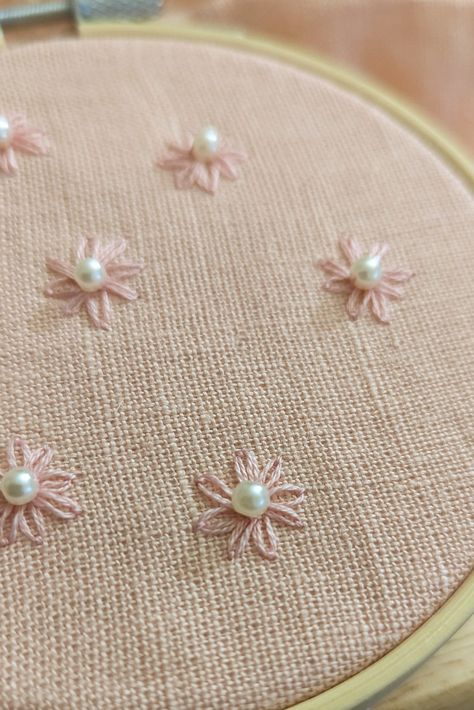 Pink daisy with pearl accent on pink linen, floral embroidery Pearl Flower Embroidery, Pearl Bead Embroidery, Embroidery On Pink Fabric, Embroidery With Pearls, Pink Flower Embroidery, Dainty Embroidery, Painting Shoes, Sweatshirt Makeover, Hand Embroidery Patterns Free