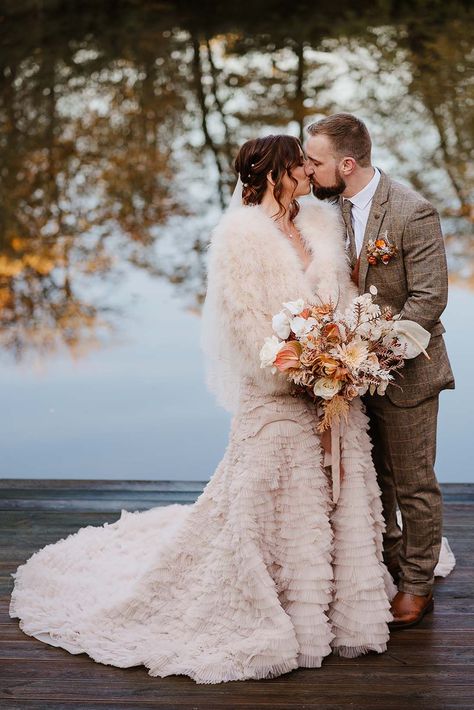 Bride in ruffle wedding dress with fur jacket for chilly autumnal wedding with the groom in brown wedding suit Dress With Fur Jacket, Wedding Dress With Fur, Reception Outfit Change, Brown Wedding Suit, Wedding Dress Couple, Styal Lodge, Dress With Fur, Winter Wedding Fashion, Winter Wedding Bridesmaids