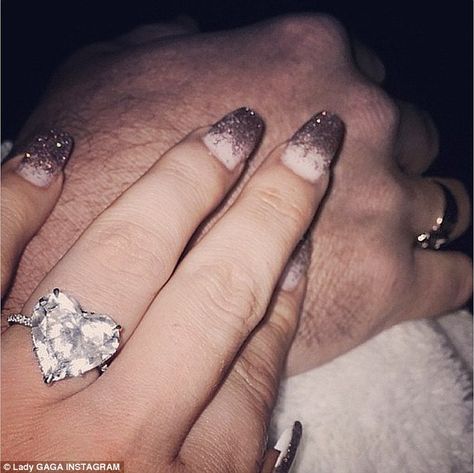 Loved up: Lady Gaga posted a picture of herself holding hands with fiancé Taylor Kinney while showing off her heart-shaped diamond engagement ring in an Instagram picture posted on Sunday evening Lady Gaga Engagement Ring, Heart Shaped Diamond Engagement Ring, Cold Play, Heart Shaped Engagement Rings, Summer Walker, Fine Engagement Rings, Taylor Kinney, Engagement Celebration, Celebrity Engagement Rings