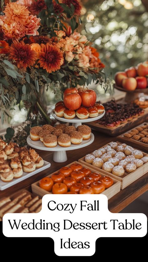 A cozy fall wedding dessert table featuring apple cider donuts, pumpkin pie bites, caramel-dipped apples, and spiced cookies displayed on rustic wooden trays with burlap accents and warm-toned flowers for a seasonal celebration. Fall Wedding Food Table, Thanksgiving Dessert Table Decoration, October Wedding Food, Fall Food Table Display, Non Cake Wedding Desserts, Fall Wedding Foods, Fall Baby Shower Dessert Table, Fall Baby Shower Desserts, Wedding Desserts Other Than Cake