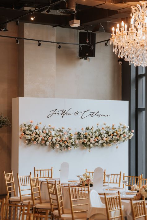 Beautiful wedding backdrop decorated with flowers and the couple's name in acrylic die-cut Square Backdrop Wedding, Wedding Alter Flowers, Flowers Installation, Dekor Lamaran, Flower Decor Ideas, Peach Blush Wedding, Wedding Themes Ideas, Article Ideas, Minimalist Wedding Reception