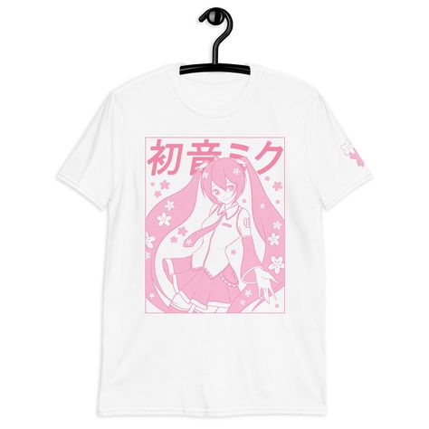 A pastel pink Sakura Miku Tee, with a Yume Kawaii vibe!  Printed via Direct-to-Garment method for a matte finish that blends well with the fabric without excess edges. American sizing! Size chart on the last image. ❤ 100% ring-spun cotton ❤ Pre-shrunk ❤ Shoulder-to-shoulder taping ❤ Blank product sourced from Bangladesh, Honduras, Haiti, Mexico, or Nicaragua Pink Shirt Aesthetic, Miku Shirt, Kawaii T Shirts, Pastel Color Shirts, Fairycore Shirt, Cute Cherry Blossom, Cherry Blossom Shirt, Kawaii Spring, Sakura Miku