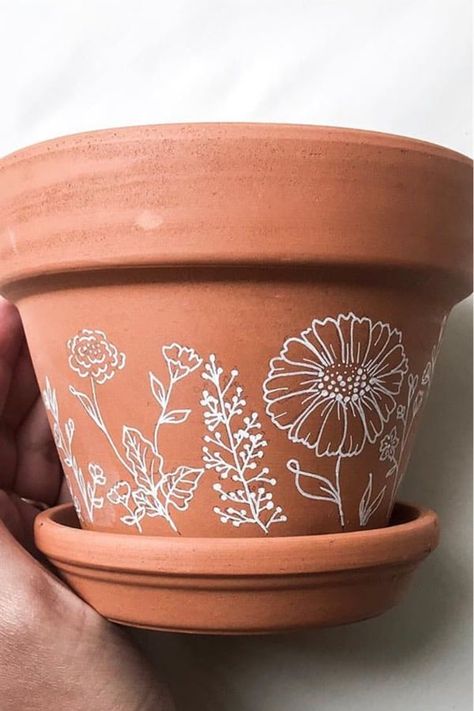 Whether you want to add some decoration to your terracotta pots or you want to transform your planters with a hand painted boho vibe… check out these awesome home DIY painted flower pot ideas for inspiration to make yours perfect! #paintedflowerpot #gardenideas #diy #gardenprojects Gold Terracotta Pots, Terracotta Pot Makeover, White Painted Terra Cotta Pots, Painted Terra Cotta Pots Ideas Simple, Flower Pot Stencil, Boho Plant Pots Diy, Terracotta Pot Decorating Ideas, Flowerpots Painting Ideas, Painted Tara Cotta Pots