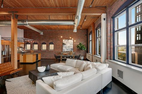 A loft apartment can be a great choice for renters looking for a spacious place in the city with industrial charm. Here's what to know about lofts. The post What is a Loft Apartment? Living Life at the Top appeared first on Redfin | Real Estate Tips for Home Buying, Selling & More. New York Loft Apartment Industrial, Open Loft Apartment, New York Loft Apartment, A Loft Apartment, Apartment Industrial, New Yorker Loft, Loft Apartment Industrial, Nyc Studio Apartments, Loft Type