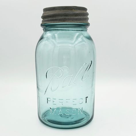 "What makes this quart-sized Ball PERFECT MASON jar rare is that it should not exist! The 'Ball Blue' PERFECT series ended in 1922, and the logo on this jar was only used from 1923 to 1933. (Notice there's no underscore.) This jar was one of the last in the PERFECT series but one of the first with the 'new' logo.  The color of this quart-sized Perfect Mason Ball jar is commonly referred to as \"Ball Blue\", a color that came from sand used to make glass taken from the Hoosier Slide sand dune on Antique Dishes Collectible, Milk Glass Decor, Ball Canning Jars, Vintage Glassware Antiques, Old Glass Bottles, Ball Jar, Glass Art Pictures, Blue Glass Bottles, Vintage Mason Jars