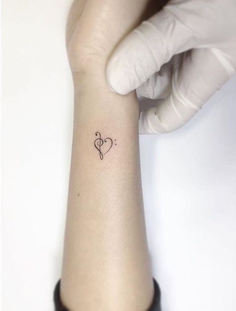 Over The Heart Tattoos For Women, Bass Clef Treble Clef Heart Tattoo, Music Heart Tattoo Designs, Treble And Bass Clef Heart, Treble Bass Clef Tattoo, Small Bass Tattoo, Treble Clef And Bass Clef Tattoo, Treble Clef Bass Clef Tattoo, Treble Bass Clef Heart Tattoo