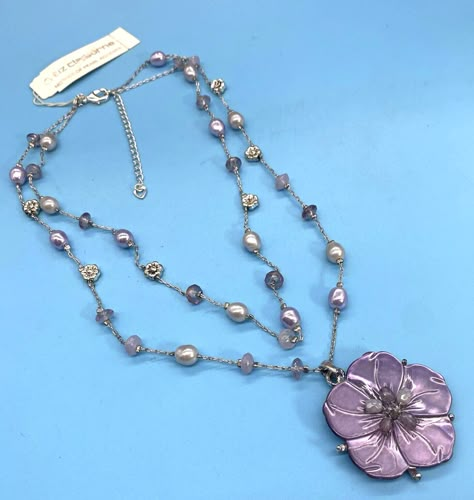 Liz Claiborne / Mother of Pearl / Carved Flower / with Pearl Center Beaded two Stand Necklace / Vintage / 1990's Add a touch of elegance to your outfit with this vintage Liz Claiborne necklace. The pendant features a beautiful carved flower with a pearl center, freshwater pearls, and mother of pearl. The necklace is 16 inches long plus 2-inch extension and has a lobster closure. This necklace is perfect for any occasion, whether it's a casual day out or a special event. The silver-tone color metal and beaded style chain create a beachy, inspirational vibe. Don't miss out on this original piece of beauty from the 1990s. Fast Ship! We Ship Every Day except Sundays & Post Office Holidays. Please look at the pictures and read descriptions carefully before you purchase.  Items are sold “as is” Y2k Statement Necklaces, Homemade Necklaces, Vintage Pendant Necklace, Vintage Liz Claiborne, Vintage Beads Necklace, Vintage Necklaces, Dope Jewelry, The 1990s, Handmade Wire Jewelry