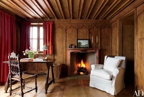 In the second master bedroom, a 19th-century painted mantel offsets the honey-tone paneling | archdigest.com Painted Mantel, Studio Peregalli, Spanish Chair, Chalet Interior, Swiss Chalet, Rustic Background, Attic Renovation, Attic Remodel, Chic Cottage