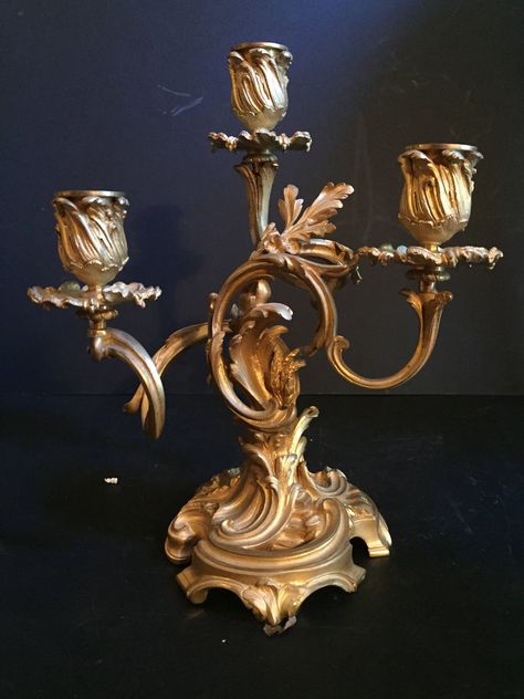 "This stunning sculptural pair of 19th Century gilt bronze Louis XV style candelabras has three candle holders each. The base features beautifully formed curling floral leaf branches which rise to hold the candle cups. The bronze design and casting is spectacularly executed. This pair has the best fire gilding possible and is among the highest quality. Condition : One bobeche is missing. (pictured) Otherwise perfect. Size: H 10\" x W 8 ½\" x D 5\" each Free Shipping for all Domestic Orders INCLU Antique Candle Holders Vintage, Golden Candle Holders, Diy Lantern Lights, French Antique Decor, Candle Opera, Fancy Candle Holders, Antique Candle Holders, Victorian Candles, Antique Lights