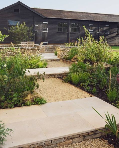 Artisan Landscapes ® on Instagram: "The stepped walkway leading up to the new terrace and old stables. Purbeck walling, limestone paving and Cotswold gravel combine to create a gentle level change, softened by the bordering plants." Limestone Gravel, Old Stables, Limestone Paving, Gravel Landscaping, Paving Ideas, Gravel Garden, Farmhouse Garden, Traditional Farmhouse, The Courtyard