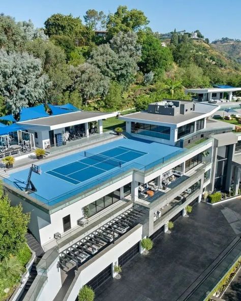 This 32,000 sqft mansion has all the amenities you could need to entertain a small city and it's asking $65 million... or $275,000 lease per month. It includes a designer kitchen with a chef's kitchen, a 5,600 sq ft primary suite with spa and dual closets, 12 bedroom suites, 24 baths, a theater, wine cellar, bowling alley, game room, private staff quarters, and more. Outside, enjoy 10,000 sq ft of covered patios, an infinity pool with waterfall and spa, pool cabana, sports court, pickleball... Staff Quarters, Pool With Waterfall, Modern Barn Style, Sports Court, Bedroom Suites, Covered Patios, Primary Suite, Pool Cabana, Designer Kitchen