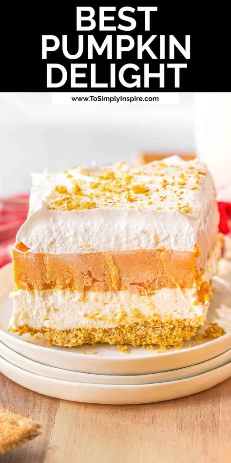 Pumpkin Delight is the luscious layered dessert you want when the fall weather hits. Delicious layers of graham cracker crust, cheesecake layer, and pumpkin pudding layer and  topped with a whipped cream layer. This fall dessert is a must-try no bake holiday recipe! Pumpkin Fluff Dessert Graham Crackers, Cheesecake Delight Dessert Recipes, Pumpkin Cheesecake Lasagna Recipe, Pie, Easy Pumpkin Delight, 4 Layer Pumpkin Delight, Halloween Cool Whip Desserts, Pumpkin Layered Dessert Graham Crackers, Pumpkin Layer Dessert