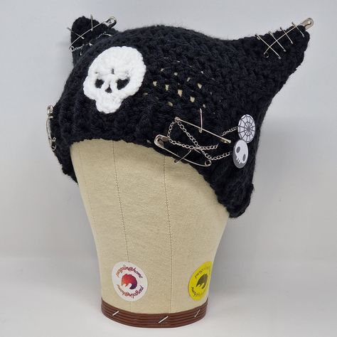 🧶 crochet hat in super soft yarn in Black with cat ears! and a skull! and safety pins!

🧶 The safety pins, pin badges and chain can all be removed or repositioned.

🧶 24cm across at the the brim, 17cm from peak to edge Crochet Cat Ear Beanie, Cat Ear Hat, Cat Hats, Cat Ear Beanie, Crochet Cat Hat, Ear Beanie, Hello Kitty Crochet, Cat Ears Hat, Cat Eared Beanie