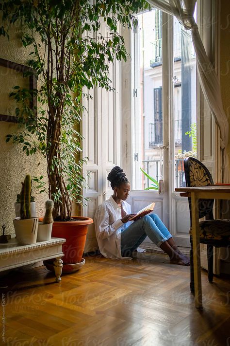 Beautiful black African woman reading a book next to a windowsill Ivar Ideas, Sitting On Floor, Background References, Female References, Drink At Home, Cozy Tea, Ballet Poses, Female Reference, Bedroom Photos