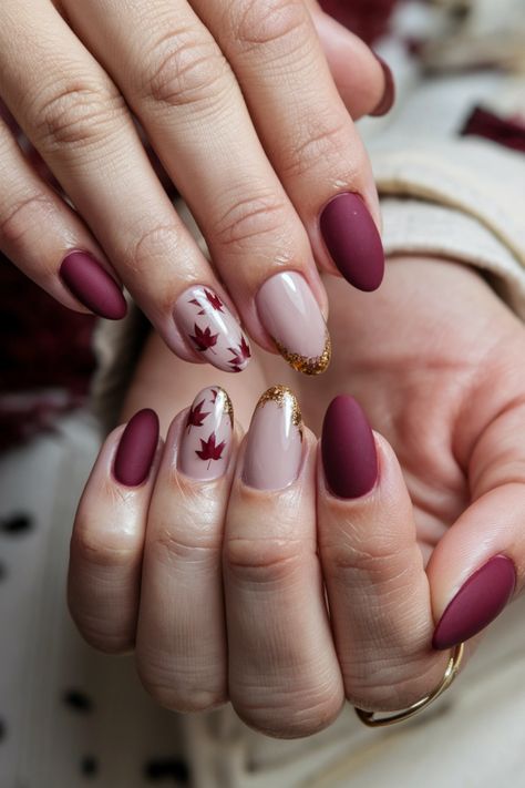 Embrace the beauty of the season with these chic Autumn short nails. Featuring a cozy mix of deep burgundy and shimmering gold accents, this stunning style captures the essence of fall perfectly. The rich colors evoke the changing leaves, making it a perfect choice for any autumn occasion. Transform your look with these delightful fall nail ideas and let your nails shine with seasonal elegance! #FallNailIdeas #AutumnNails #ChicNails #NailArt Short Nails Design Ideas 2024 Autumn, Maroon Autumn Nails, Elegant Fall Nail Art, Thanksgiving Nails Burgundy, Autumn Burgundy Nails, Fall Leaves Nails Design, Fall Nail Designs Leaves, Nail Design Ideas Fall, Autumn Design Nails