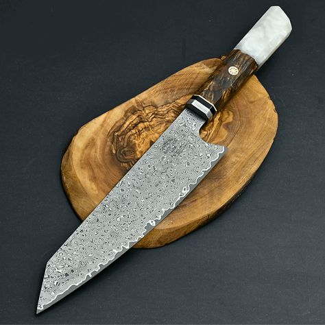 Aurora Damascus Steel Pro Chef Knife, 12.5" Overall, Damascus Steel Kiritsuke Blade with Exotic Olive Wood Burl & Resin Handle, Brass Mosaic Pins, Custom Full Tang Fixed Blade Kitchen Knife with Sheath, Knife Sharpening and Custom Personalization DAMASCUS BLADE DETAIL: The blade is expertly crafted by combining 1095 & VG10 Steel through layering, welding, and hammering, giving each blade a unique design akin to a fingerprint. Damascus steel is renowned for its strength and hardness. We enhance these properties by oil quenching it at 2100°F and cooling it rapidly, repeating the process twice to ensure its hardened to the core, achieving a hardness of 58 or higher on the Rockwell scale. SCALES & HANDLE DETAIL: The elegant handle is made from exotic olive wood burl and resin composite. It has Forge Ideas, Wood Burl, Damascus Kitchen Knives, Damascus Blade, Damascus Steel Knife, Damascus Knife, Kitchen Knife, Knife Sharpening, Chef Knife