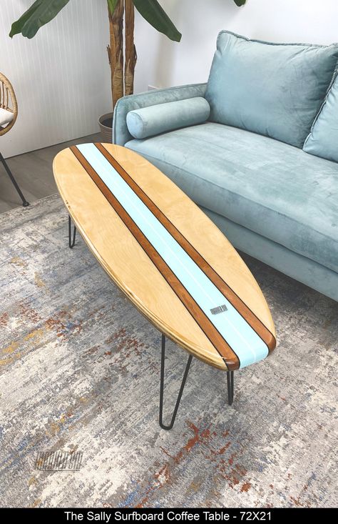 The "Sally" is a surfboard coffee table is the best of all worlds, it lets the natural wood shine, has a bit of stain and features a beautiful pale turquoise stripe from end to end with a white stringer. The finishing touch is 4 perfectly placed black pin stripes. The epoxy finish provides durability and depth to the natural wood.  Please note the grain pattern for each board will be different, but we will do our best to make is look as close to Beach Wood Furniture, Surfer Style Living Room, Hawaii Apartment Decor, Surfboard Coffee Table Diy, Decorating Beach House Ideas, Surfer Decor Surf Style Home, Beach Theme Salon, Vintage Surf Shop Aesthetic, Beach House Interior Decor