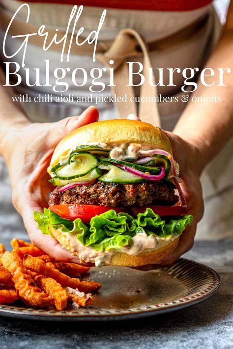 This Bulgogi Burger is a spin on the flavors of Korean Beef Bulgogi. It packs a PUNCH of flavor!! Ground beef is mixed with a bread panade that is flavored with Asian Chili Paste, Soy Sauce and Sesame Oil. Bulgogi Burger Recipe, Bulgogi Burger, Perfect Grilled Burgers, Pickled Cucumbers And Onions, Asian Chili, Chili Aioli, Korean Beef Bulgogi, Grilled Burger Recipes, Ground Chicken Burgers